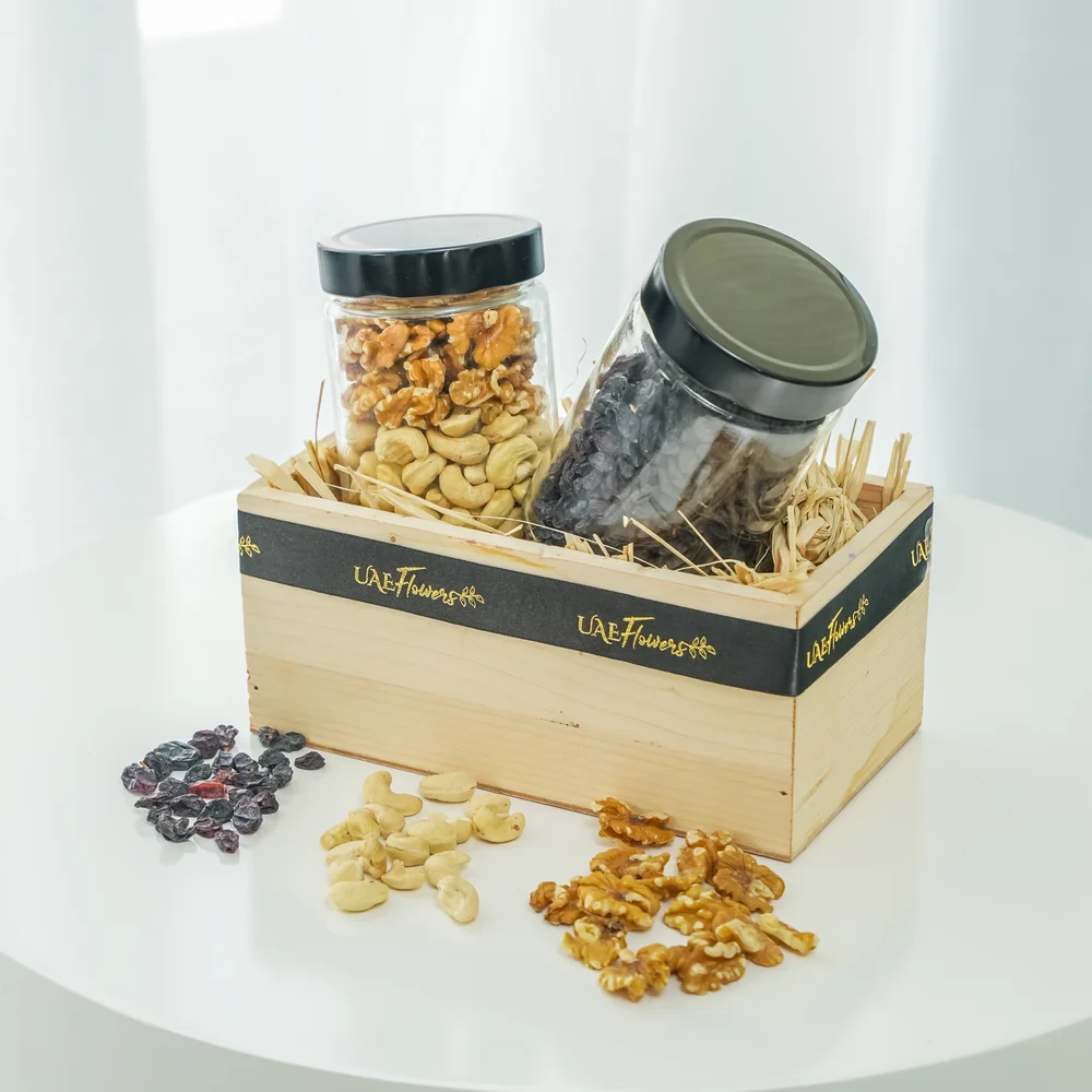 Sets of Mixed cashew & walnuts and black raisins in a wooden tray.