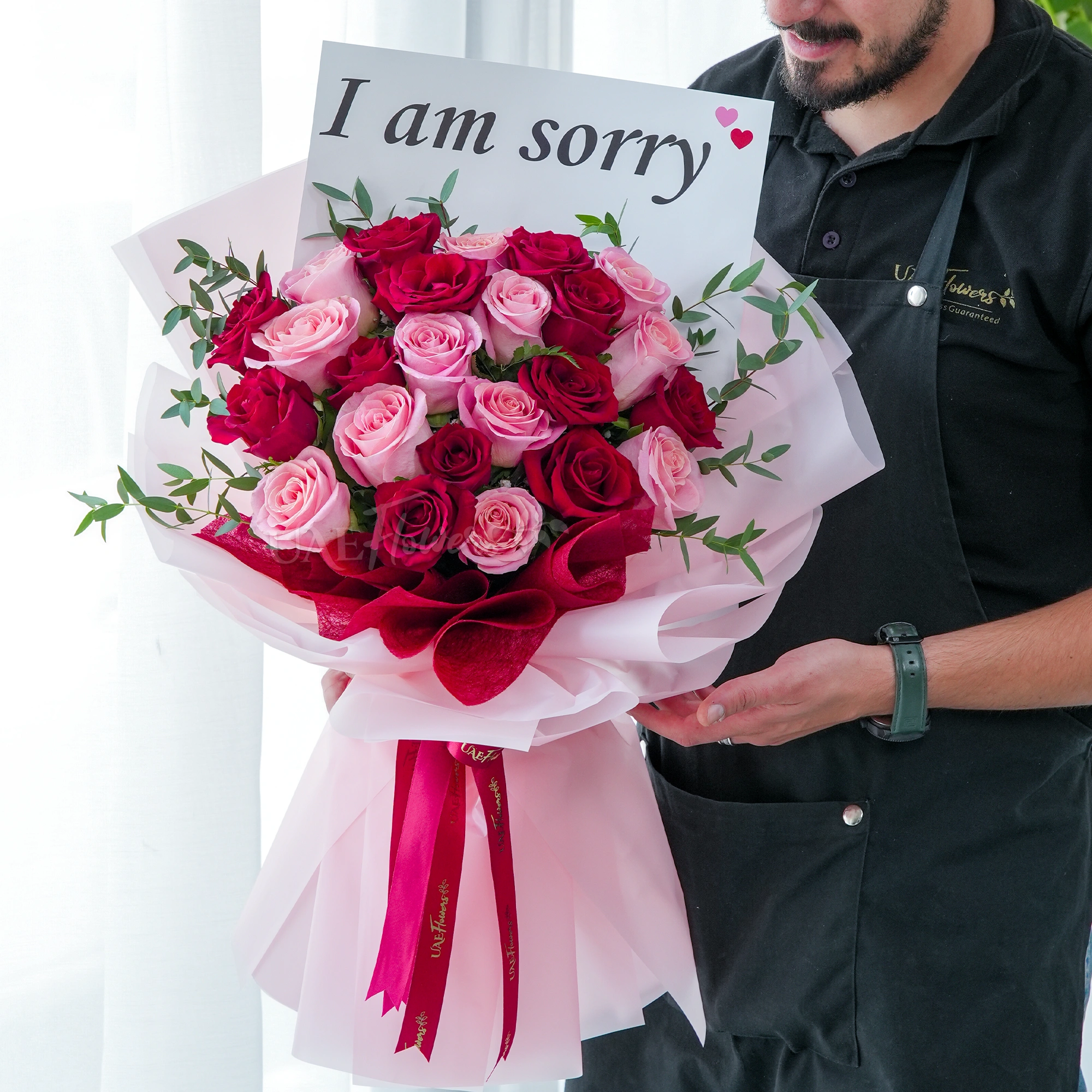 Bouquet of 24 red and pink roses with green fillers in nice wrapping.