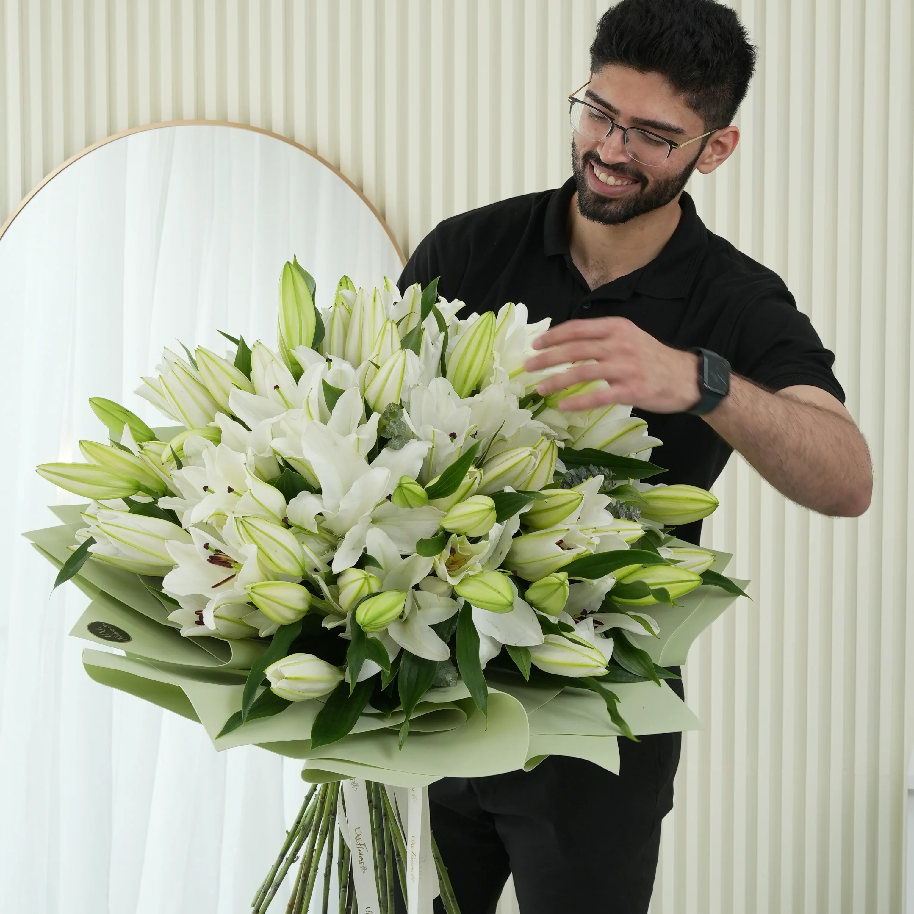 bouquet of 20 white lilies with green fillers wrapped in pastel green paper