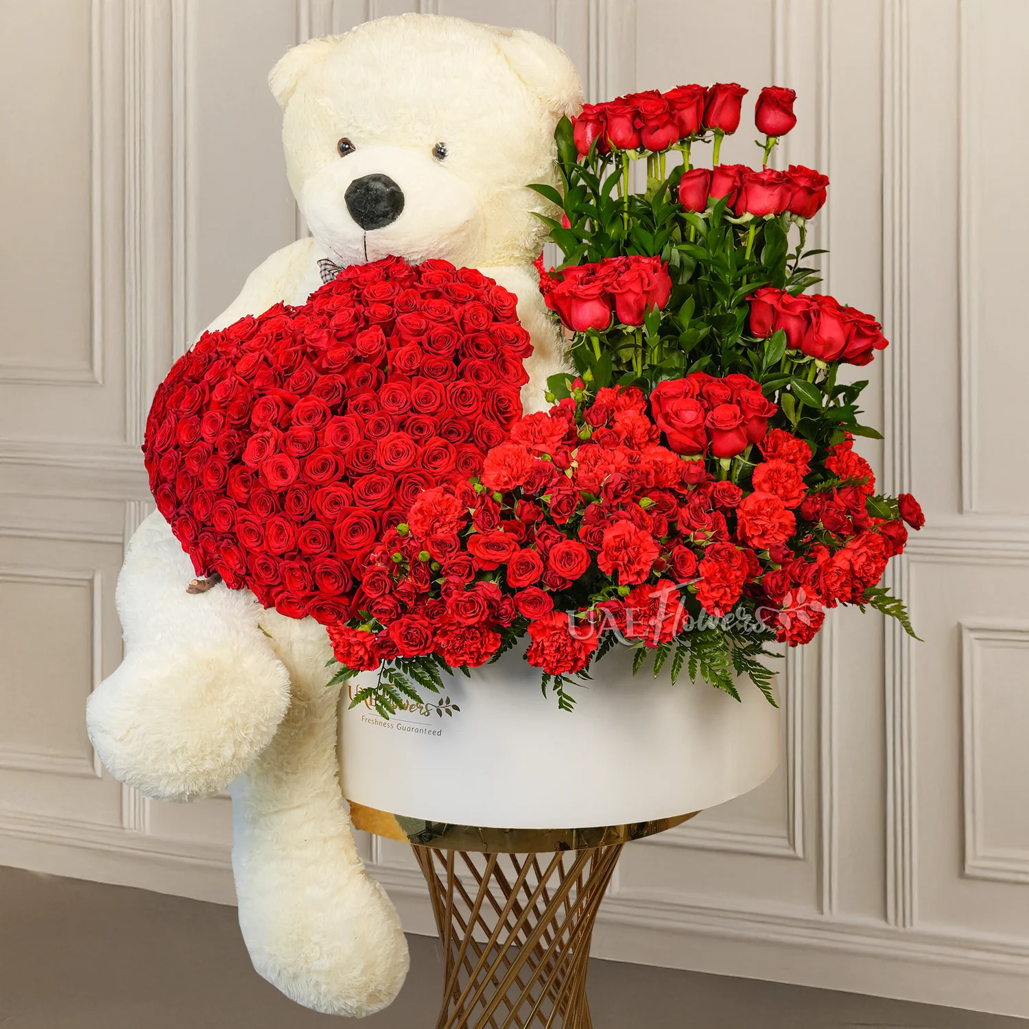 floral heart and box arrangements of 150 red roses with fillers and 1 large white teddy bear.
