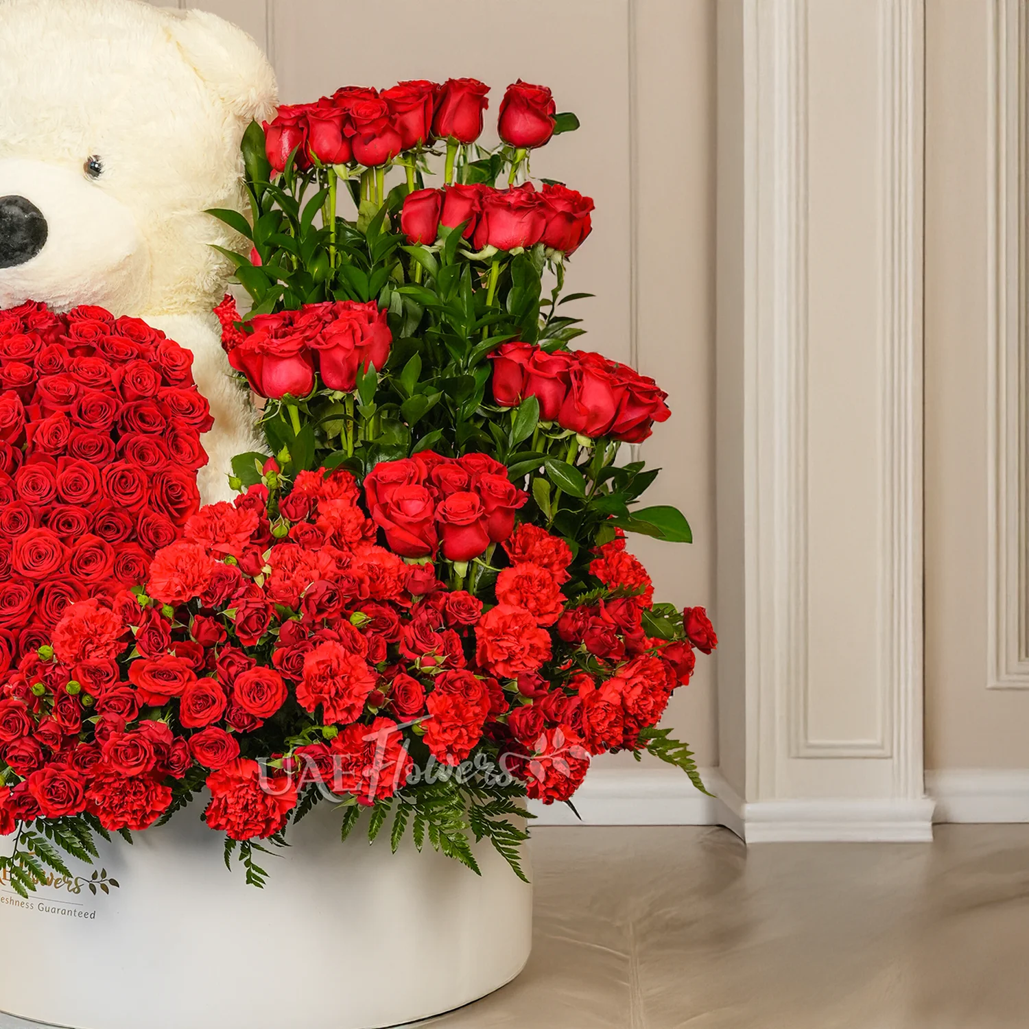 floral heart and box arrangements of 150 red roses with fillers and 1 large white teddy bear.