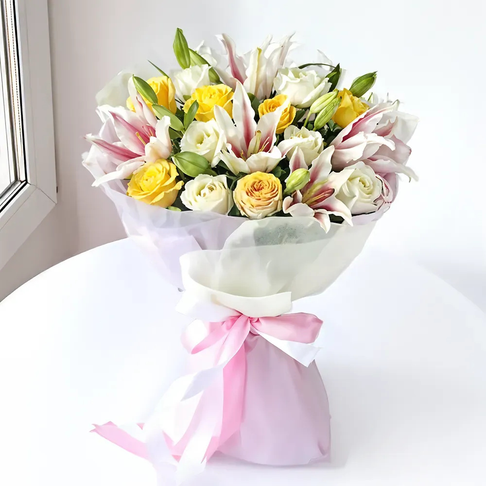 Gracefull arrangement - Bouquet of white and yellow roses with pink lilies and green fillers wrapped in pastel pink and white paper tied with a ribbon