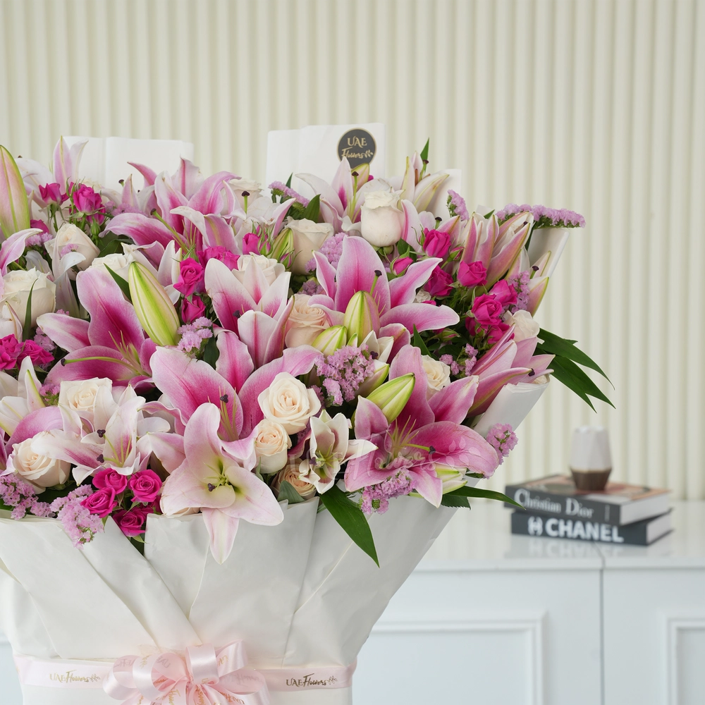 Bouquet of 10 pink lilies, 30 white roses, 10 pink spray roses with green fillers tied with ribbons.