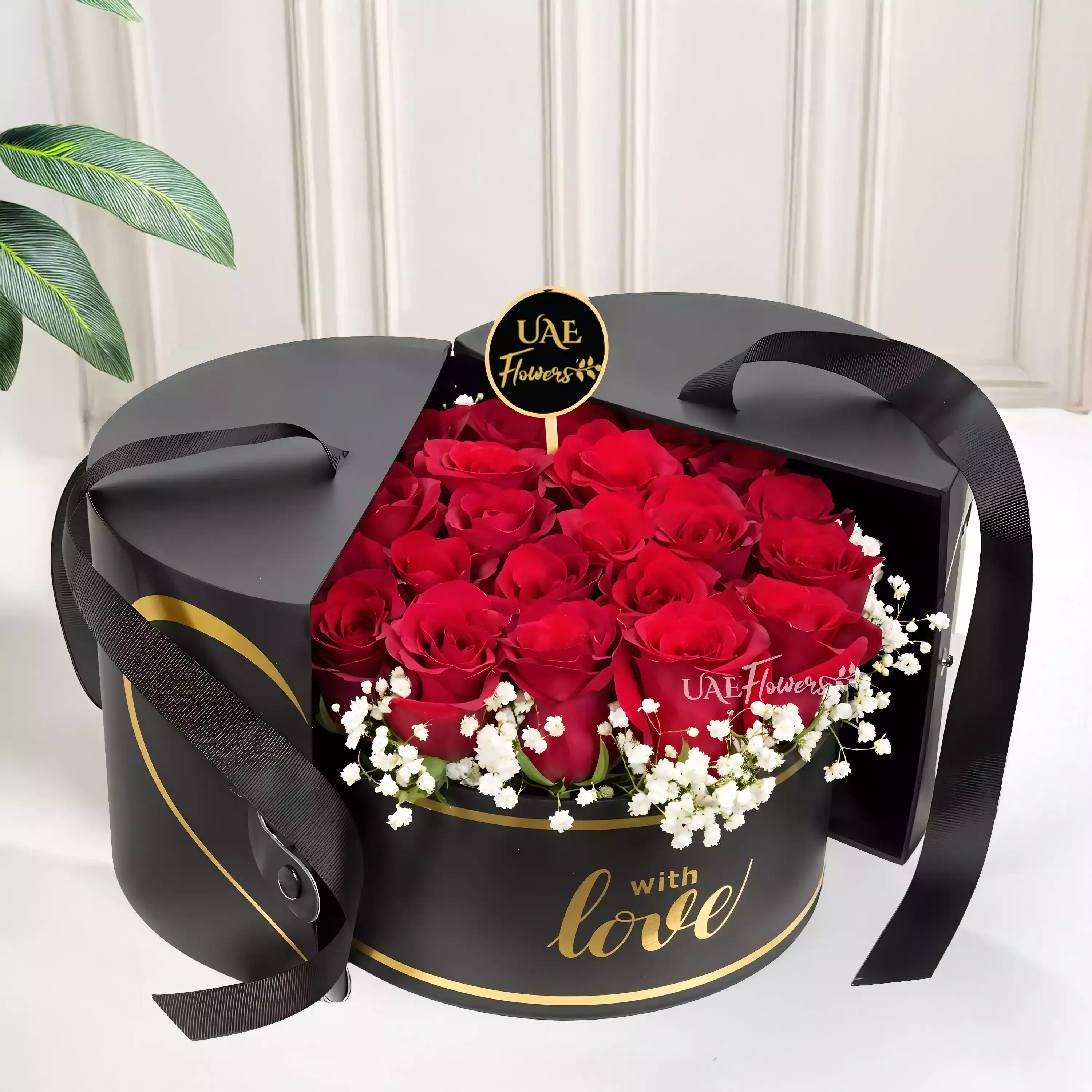 15 red roses with baby's breath arranged in a black round box