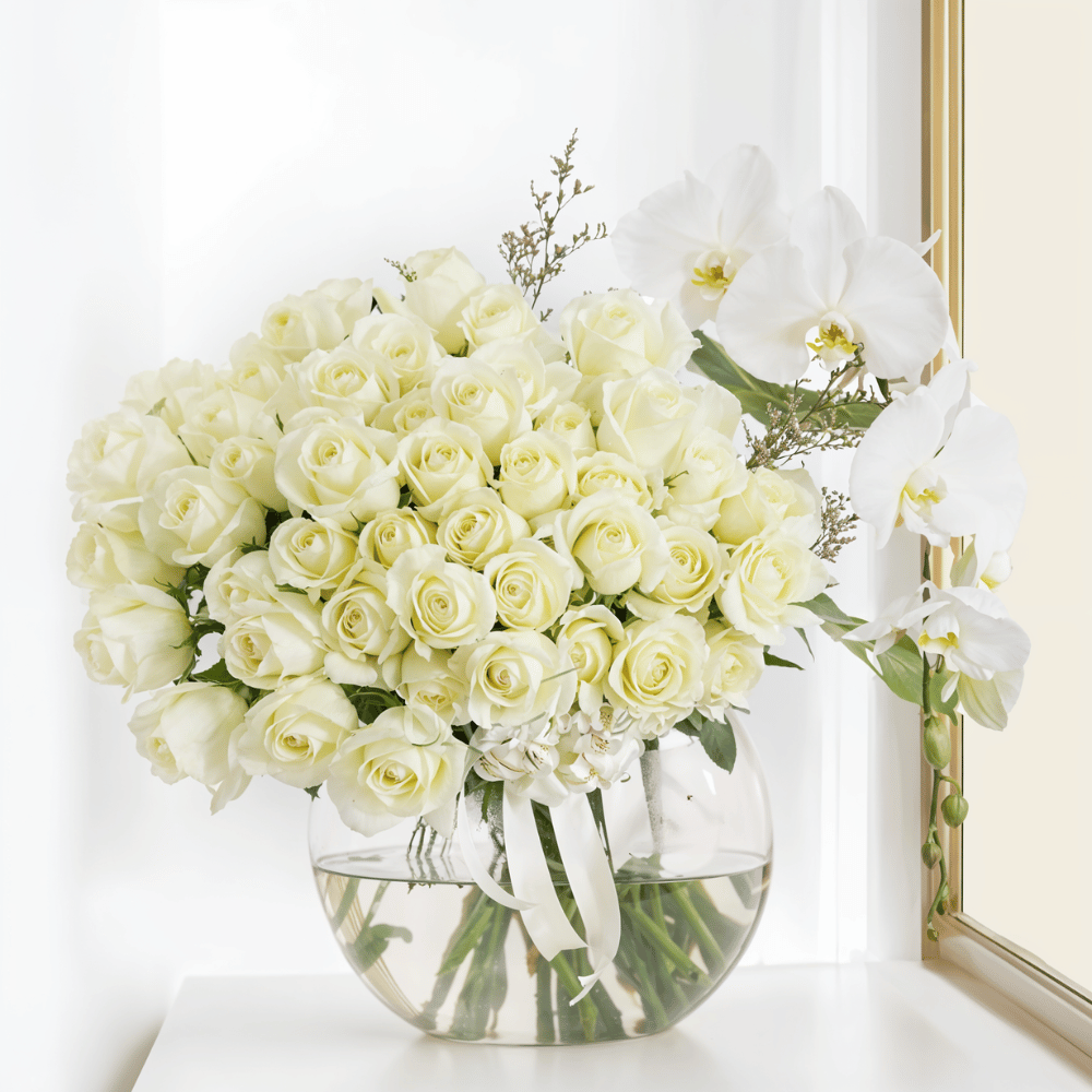 Elegant white roses in a glass vase.